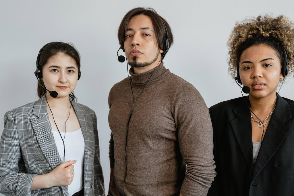 A diverse lineup of telemarketers wearing phone headsets.