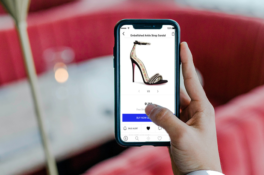 A person buying designer shoes on their mobile phone, using the Buy Now, Pay Later payment option.